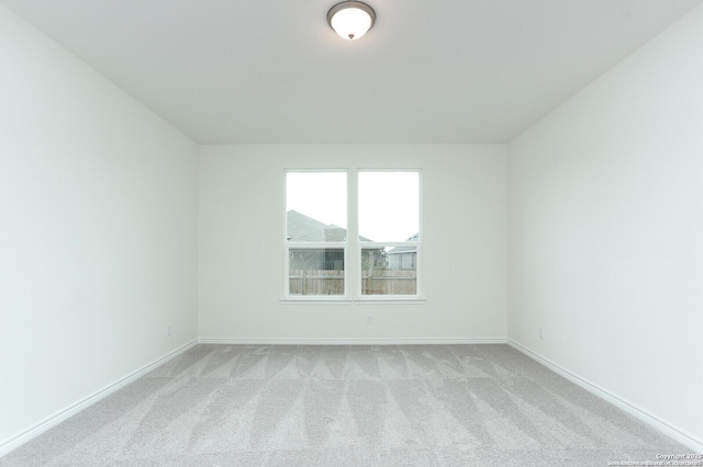 5230 Anzueto, San Antonio, TX 78261 - spare room with baseboards and light colored carpet