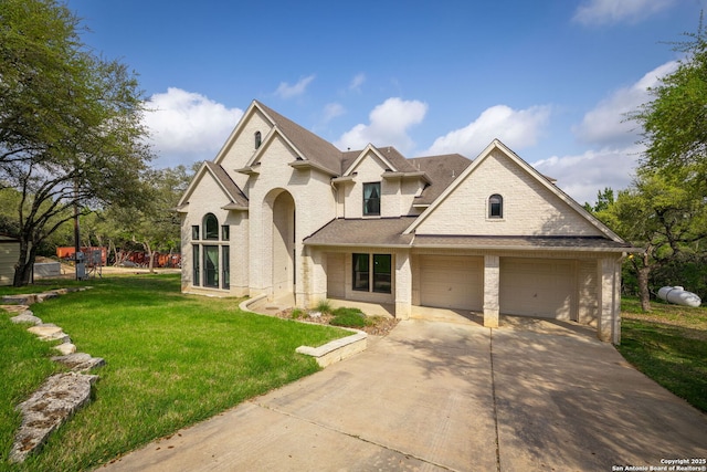 162 Teal Rdg, Canyon Lake, TX 78133 - view of front facade with brick siding, driveway, an attached garage, and a front lawn