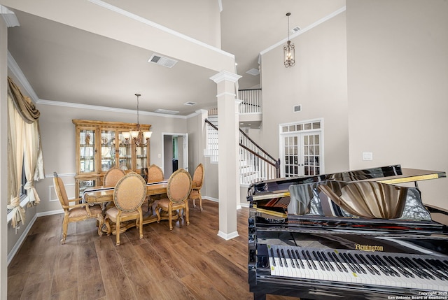 162 Teal Rdg, Canyon Lake, TX 78133 - dining room featuring crown molding, ornate columns, visible vents, a notable chandelier, and wood finished floors