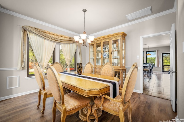 162 Teal Rdg, Canyon Lake, TX 78133 - dining room with ornamental molding, visible vents, a notable chandelier, and dark wood finished floors