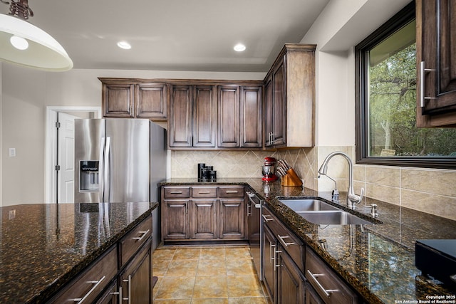 162 Teal Rdg, Canyon Lake, TX 78133 - kitchen featuring a sink, appliances with stainless steel finishes, dark stone countertops, decorative backsplash, and recessed lighting