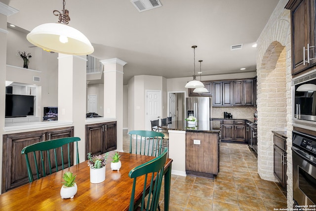 162 Teal Rdg, Canyon Lake, TX 78133 - kitchen with ornate columns, a kitchen island, appliances with stainless steel finishes, and visible vents