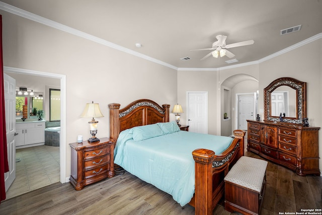162 Teal Rdg, Canyon Lake, TX 78133 - bedroom featuring visible vents, wood finished floors, arched walkways, and ornamental molding