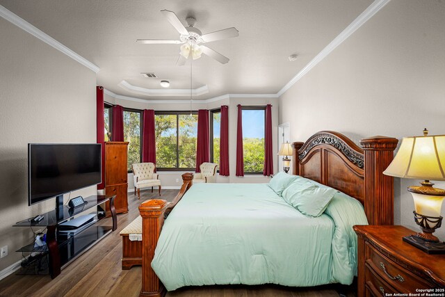 162 Teal Rdg, Canyon Lake, TX 78133 - bedroom featuring visible vents, crown molding, baseboards, and wood finished floors