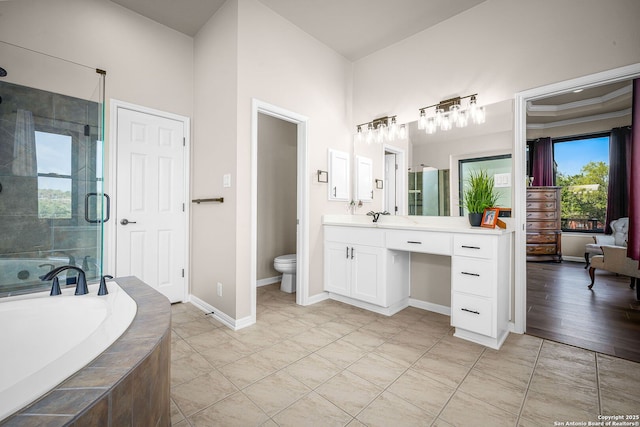 162 Teal Rdg, Canyon Lake, TX 78133 - bathroom featuring toilet, vanity, a shower stall, a bath, and baseboards