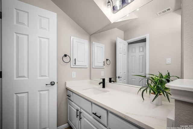 162 Teal Rdg, Canyon Lake, TX 78133 - bathroom featuring visible vents, vanity, and vaulted ceiling
