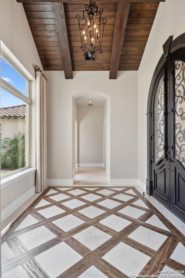 3919 El Chamizal, San Antonio, TX 78261 - entryway featuring baseboards, arched walkways, wood ceiling, and a wealth of natural light