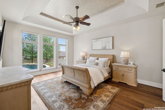 3919 El Chamizal, San Antonio, TX 78261 - bedroom featuring baseboards, dark wood finished floors, a raised ceiling, visible vents, and a ceiling fan