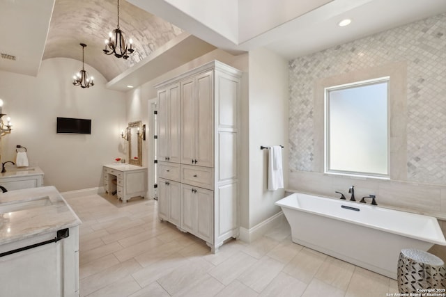 3919 El Chamizal, San Antonio, TX 78261 - bathroom with an inviting chandelier, a soaking tub, baseboards, and lofted ceiling