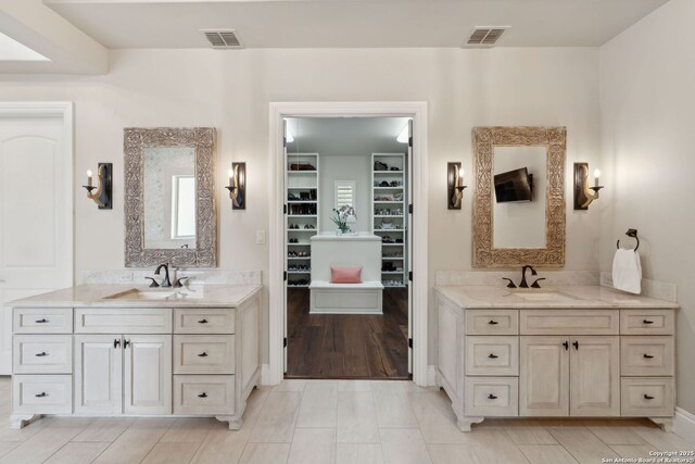 3919 El Chamizal, San Antonio, TX 78261 - full bathroom with a sink, two vanities, and visible vents