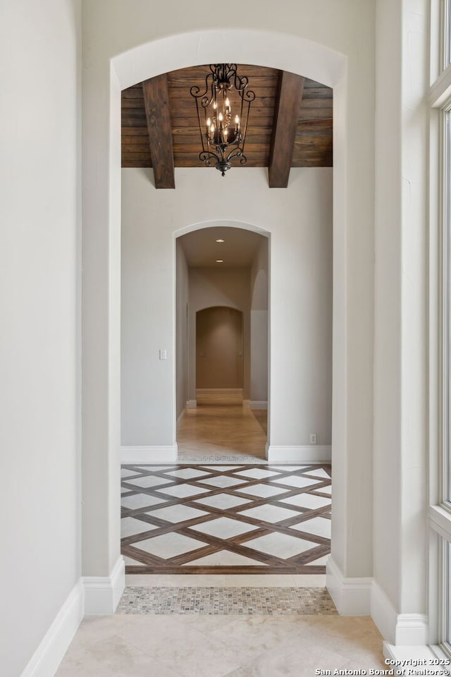 3919 El Chamizal, San Antonio, TX 78261 - hall featuring baseboards, a notable chandelier, arched walkways, and wooden ceiling