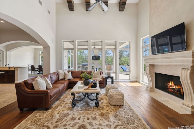 3919 El Chamizal, San Antonio, TX 78261 - living area with visible vents, hardwood / wood-style flooring, ceiling fan, a fireplace, and arched walkways