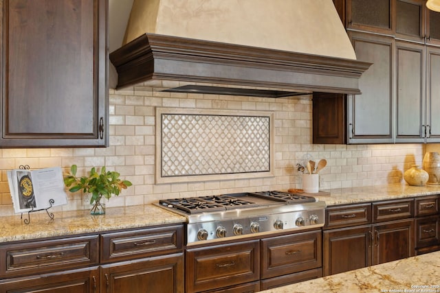 3919 El Chamizal, San Antonio, TX 78261 - kitchen with stainless steel gas stovetop, dark brown cabinetry, and custom exhaust hood