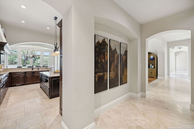 3919 El Chamizal, San Antonio, TX 78261 - hallway with arched walkways, baseboards, and recessed lighting