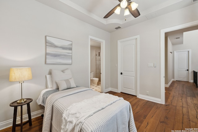 3919 El Chamizal, San Antonio, TX 78261 - bedroom featuring ensuite bathroom, visible vents, baseboards, wood finished floors, and a tray ceiling