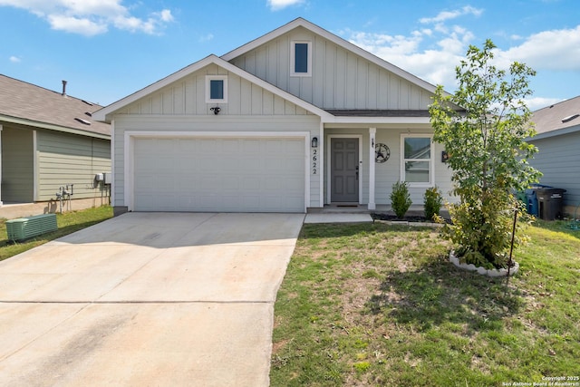 view of front of house featuring central air condition unit, an attached garage, a front yard, board and batten siding, and driveway