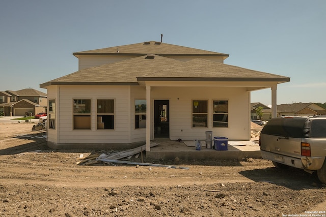 15459 Salmon Spg, San Antonio, TX 78245 - rear view of house with a shingled roof and a patio