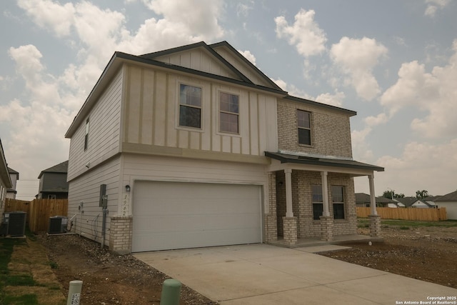 1542 Silver Run, New Braunfels, TX 78130 - view of front of house featuring board and batten siding, brick siding, central AC, and a garage