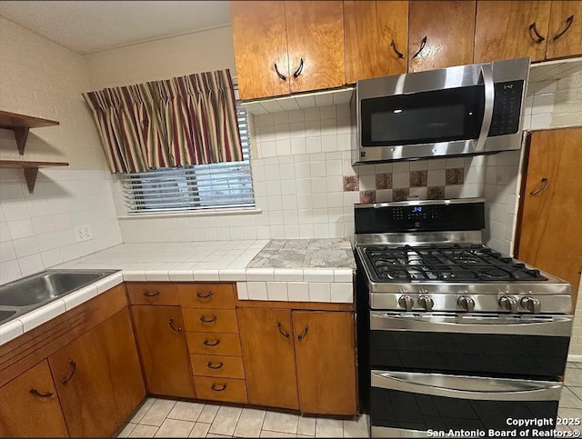 4223 Redstone Dr, San Antonio, TX 78219 - kitchen with brown cabinetry, open shelves, decorative backsplash, and stainless steel appliances