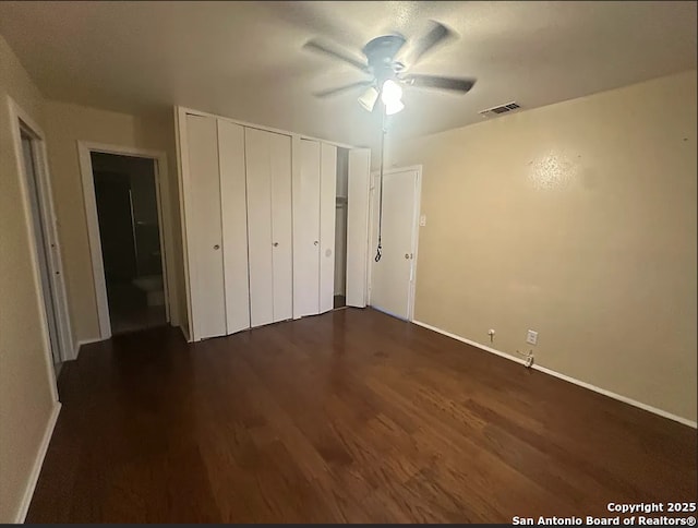 4223 Redstone Dr, San Antonio, TX 78219 - unfurnished bedroom with multiple closets, visible vents, baseboards, a ceiling fan, and dark wood-type flooring