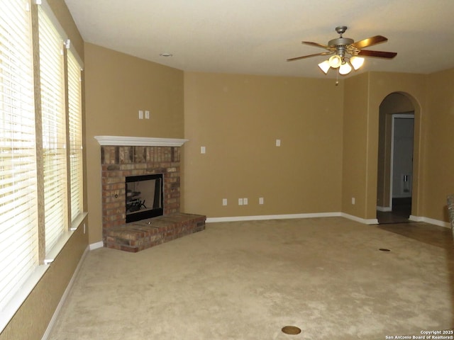 11331 Phoebe Lace, San Antonio, TX 78253 - unfurnished living room with plenty of natural light, a ceiling fan, arched walkways, and a fireplace