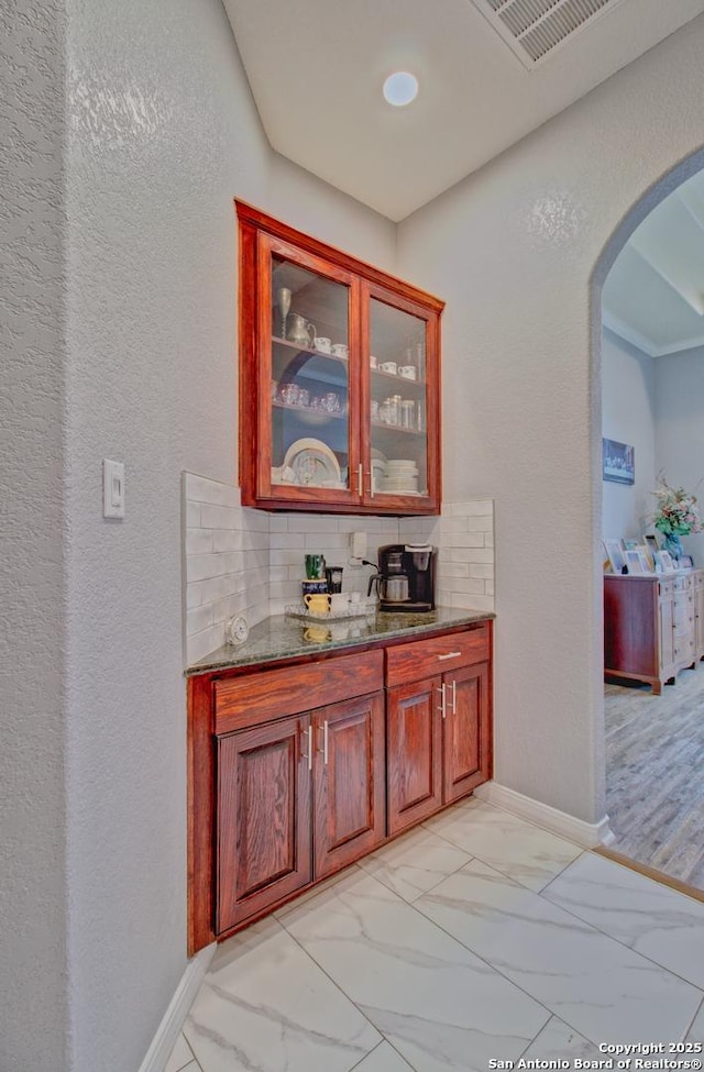 2110 Winding Vw, San Antonio, TX 78260 - bar featuring visible vents, baseboards, marble finish floor, arched walkways, and backsplash