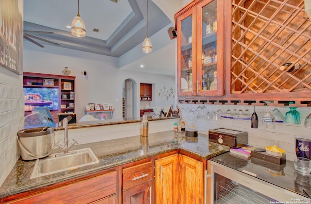 2110 Winding Vw, San Antonio, TX 78260 - kitchen with backsplash, a sink, glass insert cabinets, beverage cooler, and arched walkways