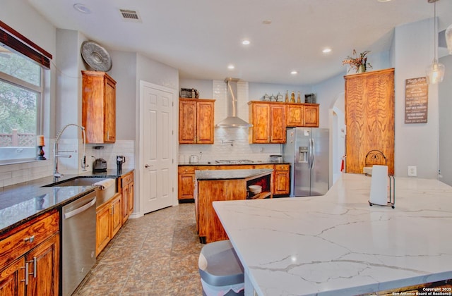 2110 Winding Vw, San Antonio, TX 78260 - kitchen with a sink, a center island, stainless steel appliances, wall chimney range hood, and decorative backsplash