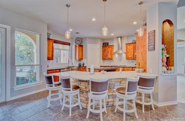 2110 Winding Vw, San Antonio, TX 78260 - kitchen featuring decorative backsplash, a sink, wall chimney range hood, a peninsula, and stovetop