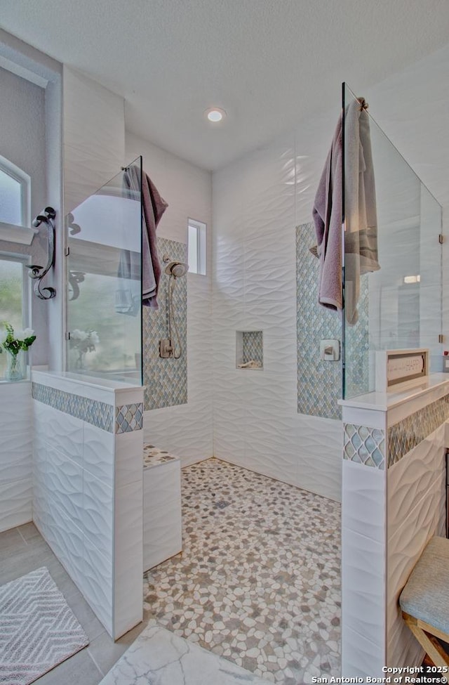 2110 Winding Vw, San Antonio, TX 78260 - full bathroom featuring a textured ceiling, a walk in shower, and a healthy amount of sunlight