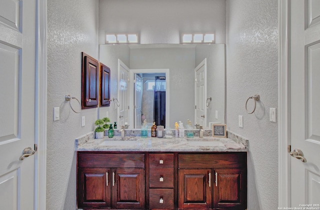 2110 Winding Vw, San Antonio, TX 78260 - bathroom with double vanity, a sink, and a textured wall