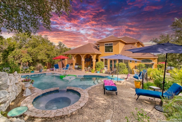 2110 Winding Vw, San Antonio, TX 78260 - pool at dusk with a pool with connected hot tub and a patio area