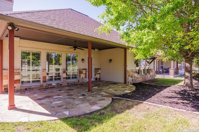 view of patio / terrace featuring ceiling fan and fence