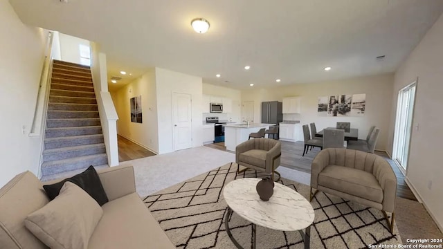 living room featuring recessed lighting and stairway