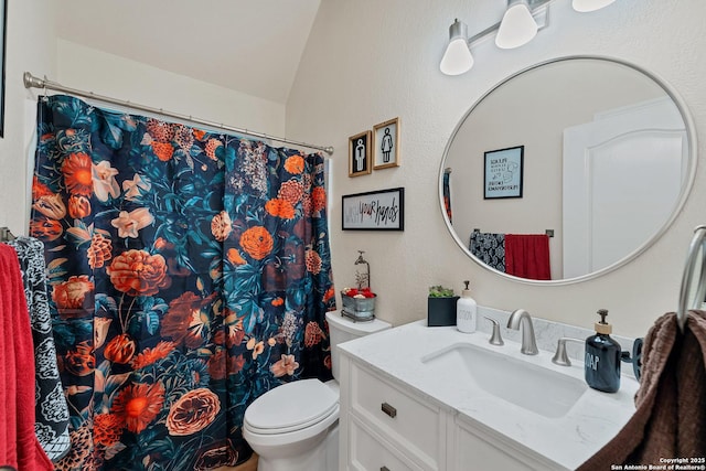 bathroom with vaulted ceiling, curtained shower, toilet, and vanity