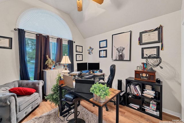 office area with baseboards, lofted ceiling, ceiling fan, and light wood-type flooring