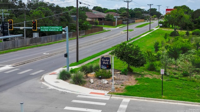 view of street with sidewalks, traffic signs, and curbs