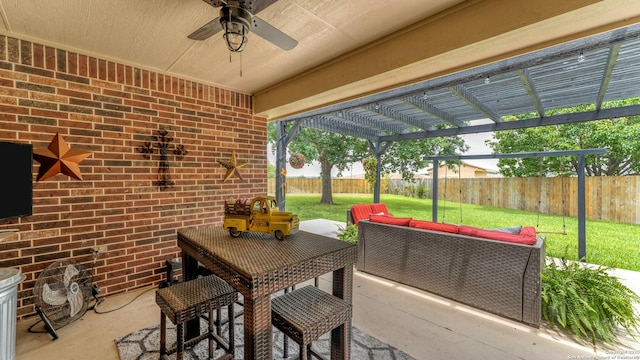 view of patio featuring outdoor lounge area, ceiling fan, a fenced backyard, and a pergola