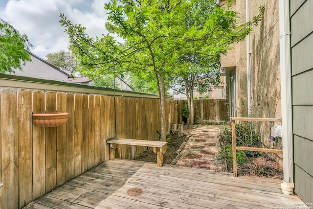wooden deck featuring a fenced backyard