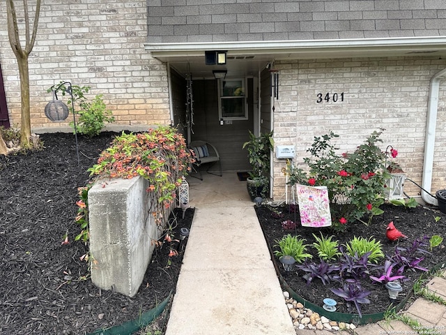 3401 Sugarhill, San Antonio, TX 78230 - view of exterior entry featuring a shingled roof and brick siding