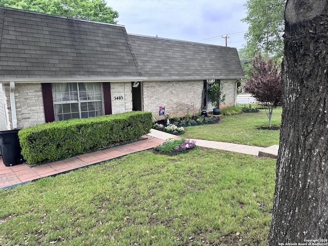 3401 Sugarhill, San Antonio, TX 78230 - view of front of home with a front lawn, mansard roof, brick siding, and roof with shingles