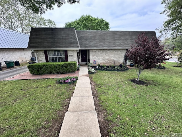 3401 Sugarhill, San Antonio, TX 78230 - view of front facade with mansard roof, brick siding, roof with shingles, and a front yard