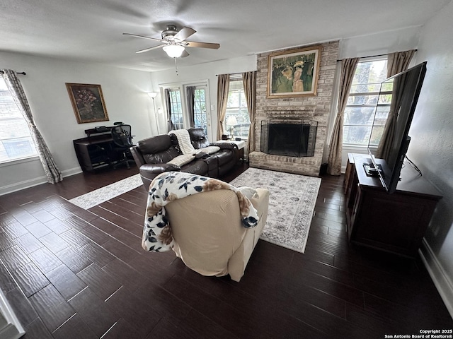 3401 Sugarhill, San Antonio, TX 78230 - living area featuring a brick fireplace, baseboards, dark wood-type flooring, and a ceiling fan