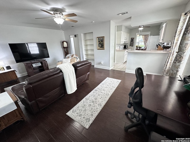 3401 Sugarhill, San Antonio, TX 78230 - living area with baseboards, built in shelves, visible vents, a ceiling fan, and wood finished floors
