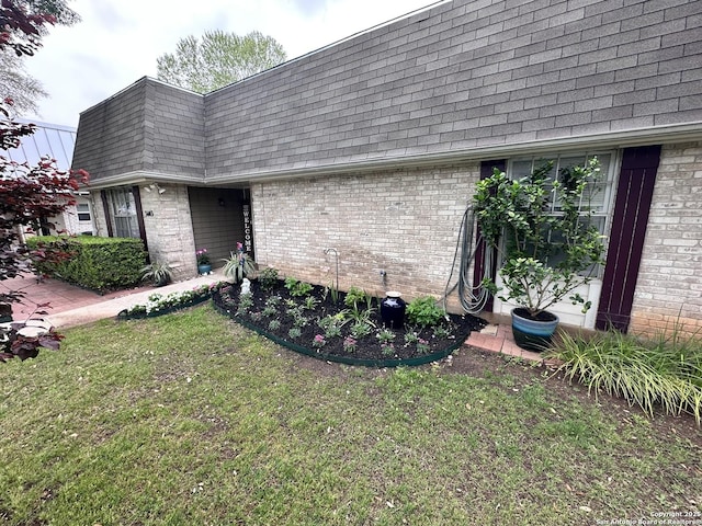 3401 Sugarhill, San Antonio, TX 78230 - view of home's exterior featuring a yard, mansard roof, brick siding, and roof with shingles