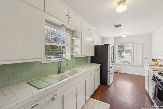 2334 W Huisache, San Antonio, TX 78201 - kitchen with backsplash, tile counters, white cabinetry, stainless steel refrigerator with ice dispenser, and range with gas cooktop