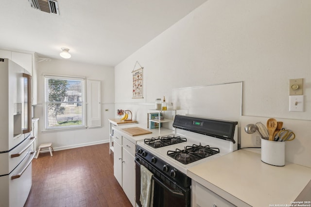 2334 W Huisache, San Antonio, TX 78201 - kitchen with light countertops, visible vents, refrigerator with ice dispenser, white gas stove, and dark wood finished floors