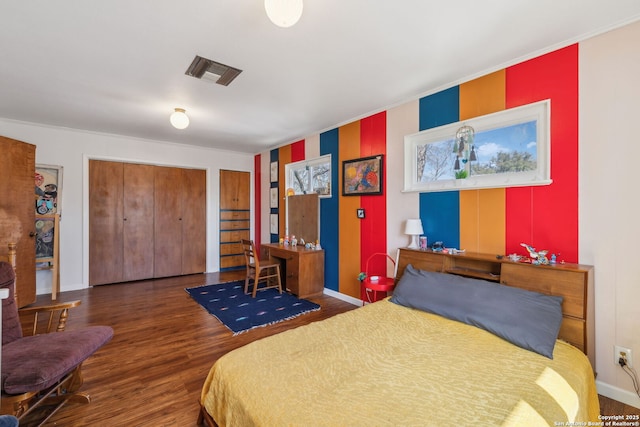 2334 W Huisache, San Antonio, TX 78201 - bedroom with baseboards, visible vents, wood finished floors, and multiple closets