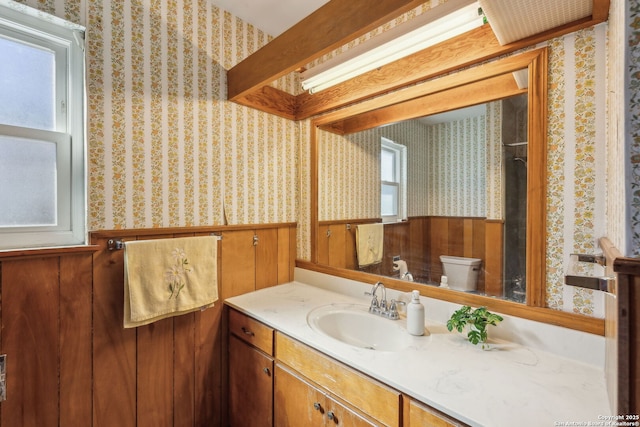 2334 W Huisache, San Antonio, TX 78201 - bathroom featuring wallpapered walls, a wainscoted wall, toilet, and vanity