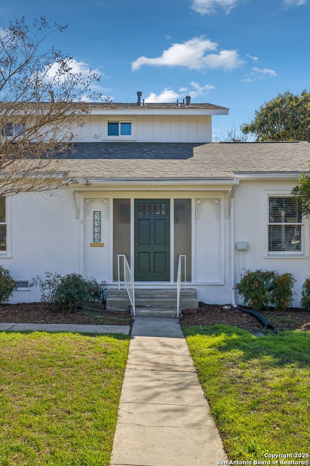 2334 W Huisache, San Antonio, TX 78201 - view of front of property with stucco siding, a front lawn, and roof with shingles